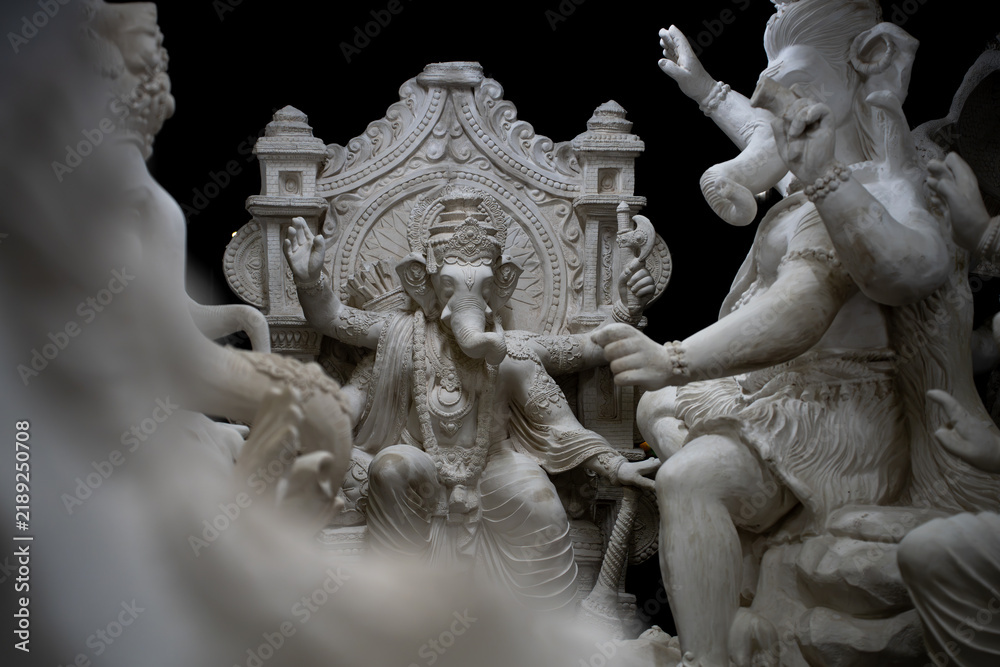 Fototapeta premium White Ganesha idol surrounded by other sculptures during a Hindu festival in India