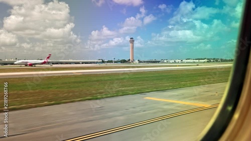 Beautiful view of Miami International Airport runway and control tower through airplane window. Miami. USA. 