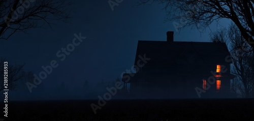 Haunted house in foggy Halloween night landscape