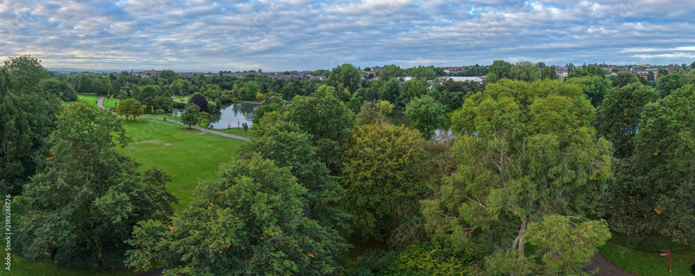 Obraz premium Panorama of Alexandra Park Woodland Canopy Boating Lake and Lawns in Oldham, Greater Manchester.