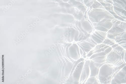 Soft sunlight caustics on white pool plaster