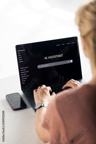 Person typing on laptop using ai assistant tool