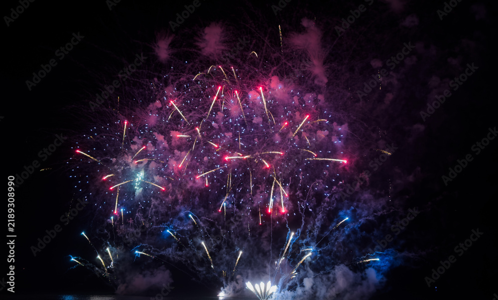 Naklejka premium Colorful fireworks over cityscape at new year night