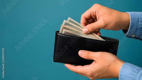 Person Holding Open Wallet with Cash Representing Personal Finance and Spending