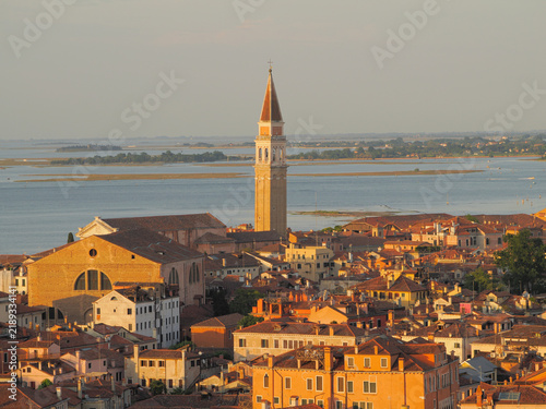 Aerial view of Venice, Italy, showing historic architecture and waterfront at golden hour. San Francesco della Vigna with Campanile in view.