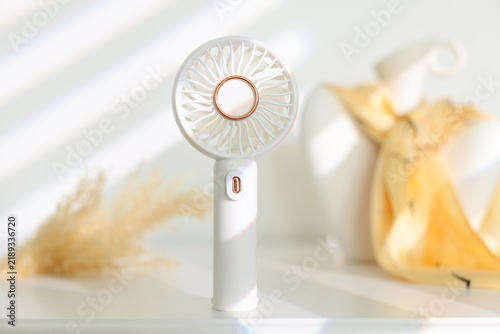 Mini fan on white table indoors, closeup