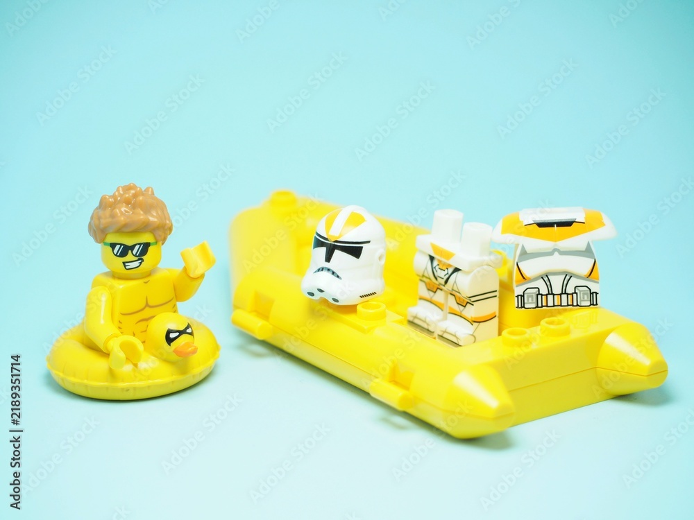 Fototapeta premium Indonesia - September 13, 2023 : Mini toy at table with blurred background. Holiday concept design. Stormtrooper take off the shield clothes or shirt and swimming in the water.