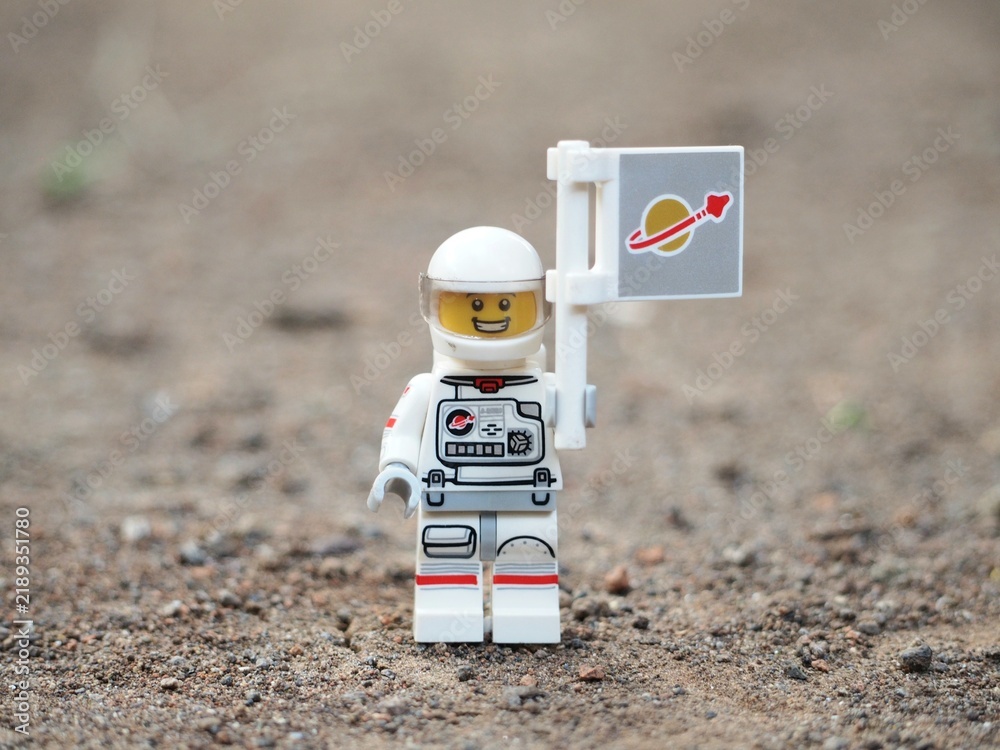 Obraz premium Indonesia - April 14, 2025 : Mini toy of action figure at table with blurred background. Miniature photography concept design. Minifigure of astronaut character at outer space.