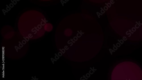 Seamless Animation of Soft Glowing Particles Slowly Flying against a Dark Dackground