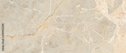 Beige marble texture with intricate white crackled veins and warm tan tones forming an elegant luxury natural stone background