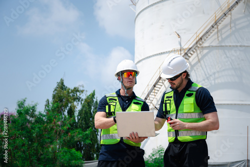 Team of petroleum engineers is inspecting and checking the system at a petroleum storage facility