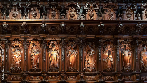 Intricate detailed wooden choir stalls with carved figures of saints inside the landmark Cathedral of Malaga (La Manquita) in Andalusia, Spain.