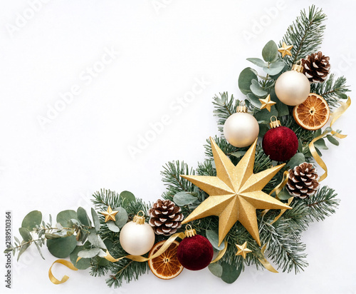 Decorative christmas corner arrangement with baubles stars pine cones and dried orange slices