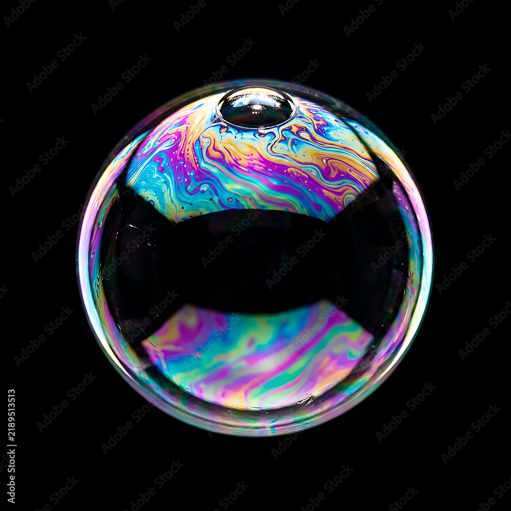 Fototapeta premium Vibrant Iridescent Soap Bubble Featuring Swirling Rainbow Patterns and Colorful Reflections Isolated on a Deep Black Background