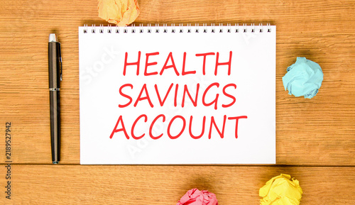 Health saving account symbol. Concept words Health saving account on beautiful white note. Beautiful wooden background. Colored paper. Medical Health saving account concept. Copy space.