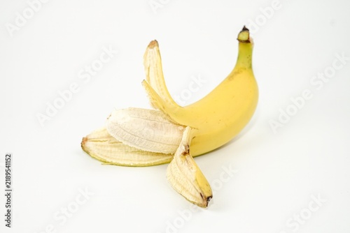Cuadro en lienzo Partially peeled ripe yellow Cavendish banana exposing the inner fruit flesh, isolated on a clean white background