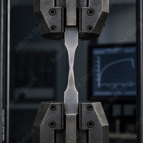 Metal specimen stretching between grips in a tensile test