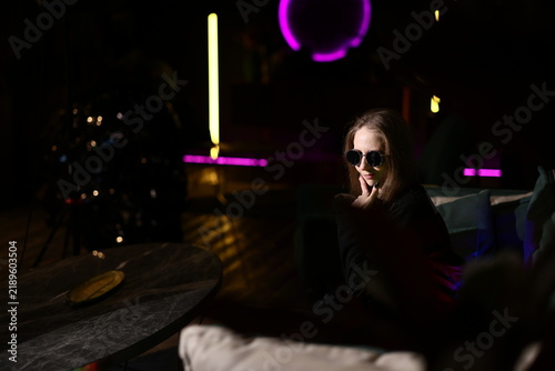 Obraz na plátně Calm female author relaxing on textured teal couch amidst shadows
