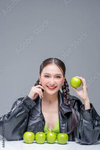 Canvastavla Trendy stylish woman balancing green apple on head, showcasing playful attitude, fashion beauty, quirky balance, youthful confidence, creative diet concept, modern wellness, and edgy cool lifestyle