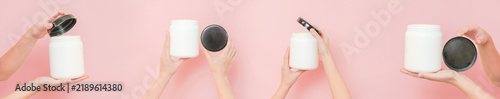 Female hands opening white cosmetic jars with black lids