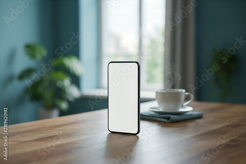 Smartphone with blank white screen standing upright on a wooden table in a cozy home office setting smartphone technology communication connected internet interior workspace lifestyle