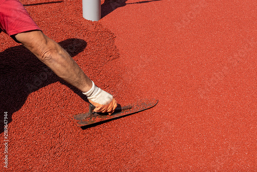 top layer consisting of EPDM spreading with hand trowel