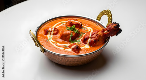 Chicken Tikka Masala in Copper Bowl: A delicious and creamy Chicken Tikka Masala, a classic Indian dish, served in a traditional copper bowl with intricate handles.