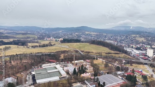 Drone Aerial Countryside Town Panorama Overcast Rolling Fields, Factory Roofs, Distant Hills, Muted Winter
