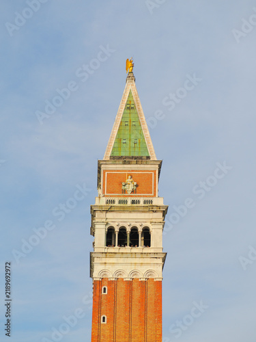 The iconic St Mark's Campanile bell tower against a clear blue sky in Venice, Italy
