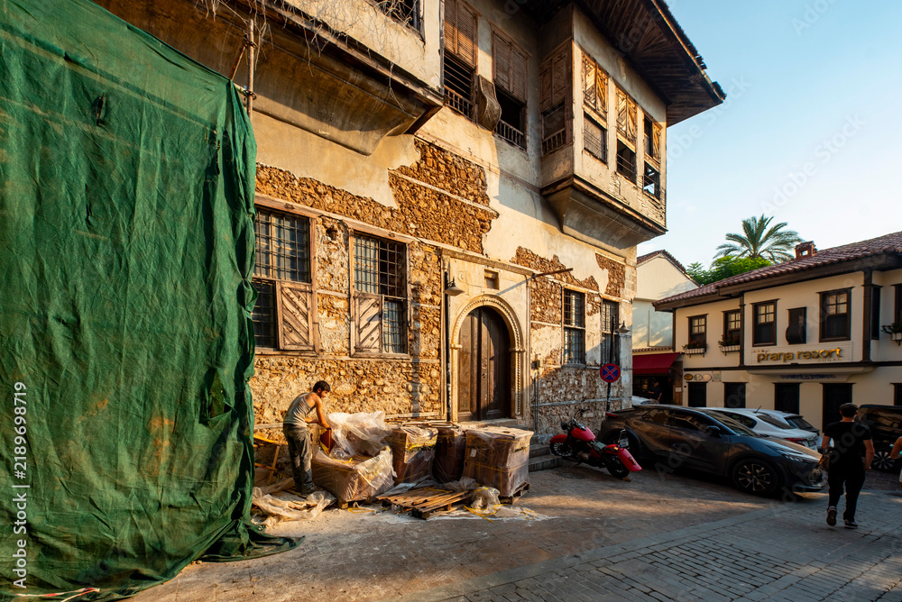 Obraz premium Antalya, Turkey - August 27, 2026: The image shows a historic cobblestone street in Kaleiçi, the old town of Antalya, Türkiye, featuring traditional Ottoman-style architecture and ancient stone. Histo