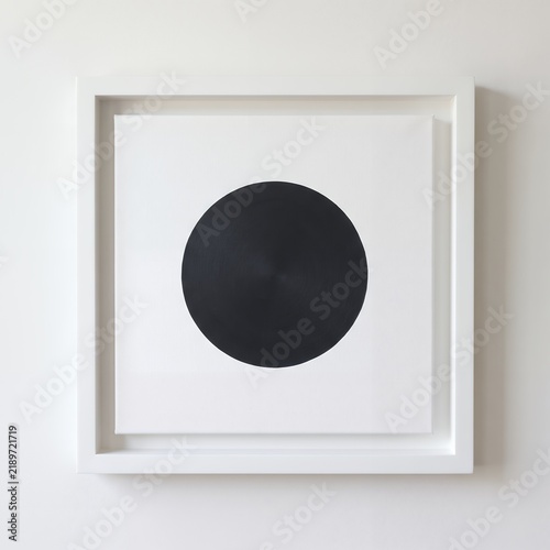 Bold black circle artwork in a white minimalist frame