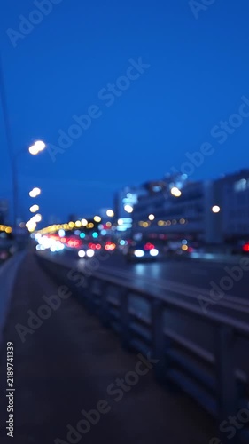 Defocused evening traffic on a busy urban highway with glowing headlights, illustrating city mobility, commuting and transportation