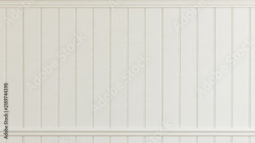 A clean white wooden wall with vertical paneling and classic molding details. This minimalist interior backdrop is ideal for product displays and home decor projects.