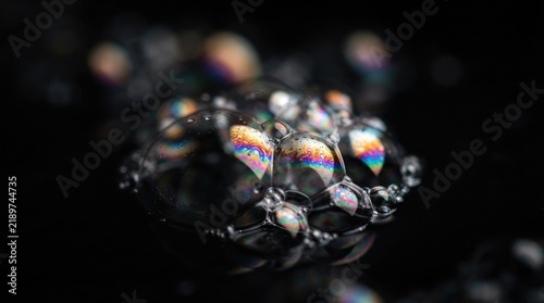Abstract Macro of Iridescent Soap Bubbles with Rainbow Colors on Dark Background