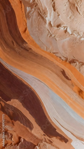 Abstract acrylic paint texture background with smooth liquid brown and beige waves resembling a natural marble slice polished agate onyx texture fluid art and creamy cosmetic foundation backdrop