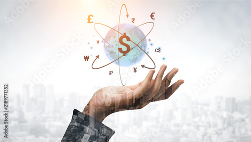 Obraz na plátně Hand Reaching Out with Globe Surrounded by Currency Symbols Representing Global Economy and Financial Markets in Modern City Background