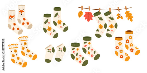 Set of illustrations of warm autumn socks with cozy patterns of autumn leaves, mushrooms, and fox. The atmosphere is autumnal, warm, and cozy