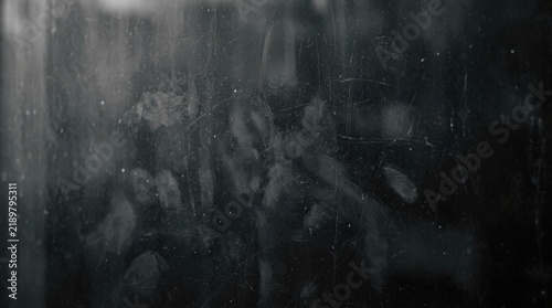 Abstract dusty glass texture with visible fingerprints and smudges