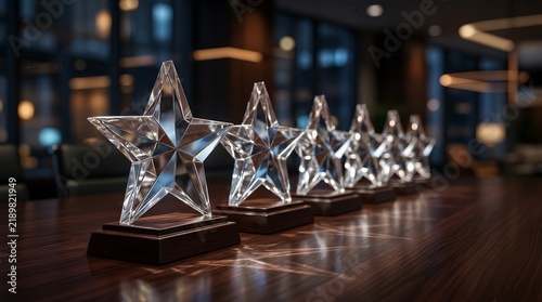 Transparent star trophies lined up in a professional business setting to represent success and achievement.