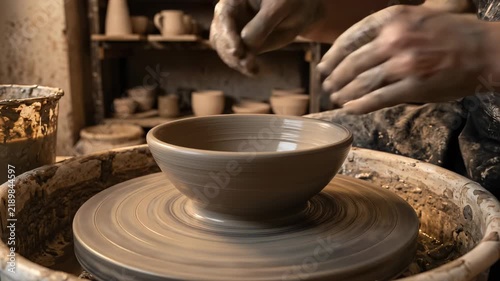 Artisan Hands Shaping Wet Clay on Pottery Wheel
