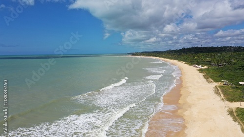Fantastic aerial view of Nativos Beach with white sand, coconut trees and tropical nature in Trancoso, Bahia, Brazil