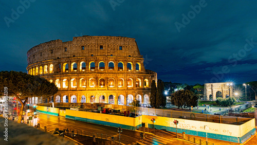 Obraz na plátně Colosseum illuminated against a dramatic night sky, Lazio, Rome, Italy