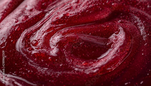 Glossy deep red liquid swirl abstract texture with smooth flowing patterns, vibrant crimson background for creative design and wallpaper
