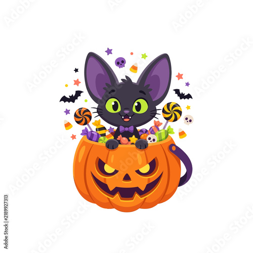 Quadro su tela Cute black cat with big ears sitting inside a carved Halloween pumpkin filled with candies and surrounded by spooky elements