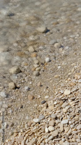 砂利の上を流れる浅い水 シームレスループ動画背景 9:16 4K
