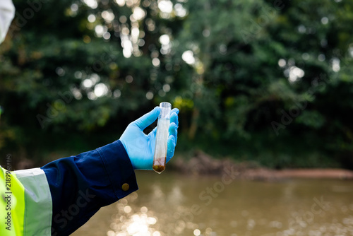 Canvas Print Environmental technician inspecting river water and sediment sample for contaminants and heavy metals