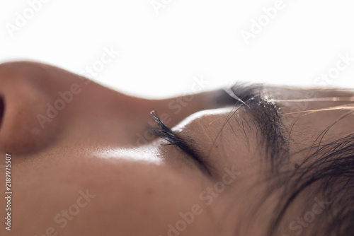 Obraz na płótnie Close up sleeping woman with closed eye and natural skin detail in soft light