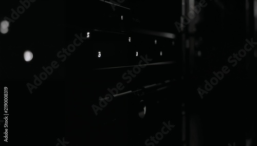 Dark Electrical Panel with Multiple Circuit Breakers and Controls in Low Light