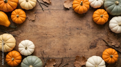 Autumn harvest arrangement of colorful pumpkins on rustic wooden background