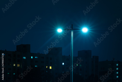 Dual Streetlight Lanterns Shining with Brilliant Starbursts at Night